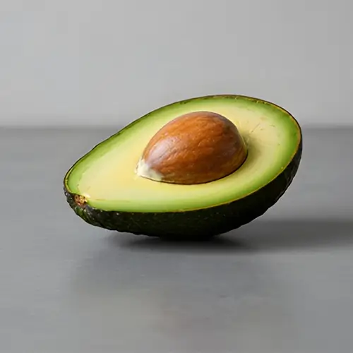 A single, perfectly ripe Hass avocado, showing texture and quality.
